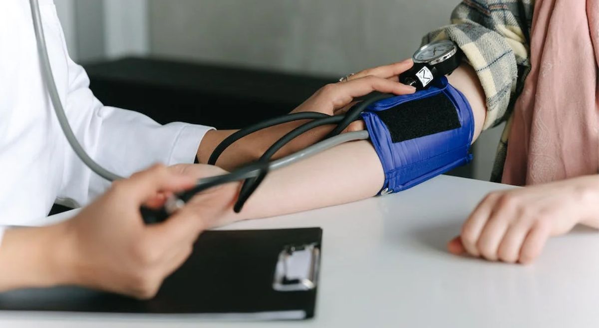 Picture of a person getting their blood pressure taken by a doctor